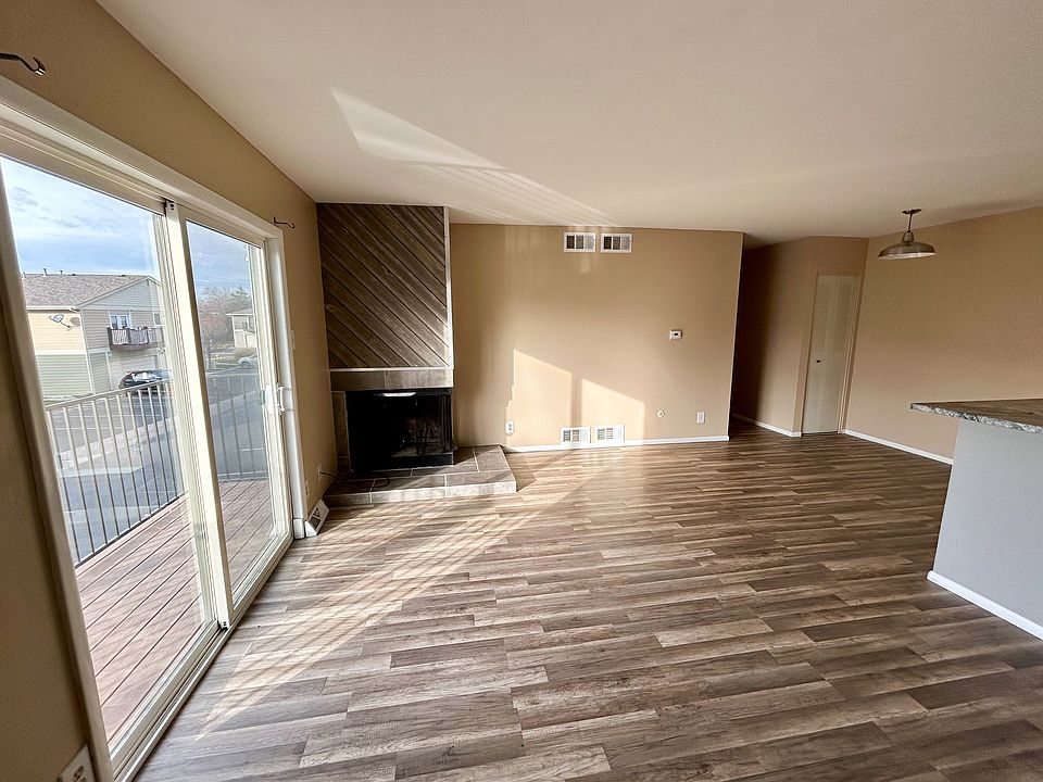 Living room with working fireplace and access to private deck.