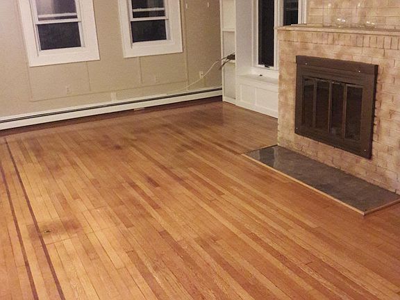 Livingroom with hardwood floors, built in shelve, storage bench & fireplace