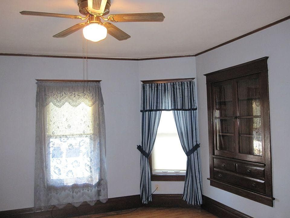 Living room with built in hutch and hardwood floor.