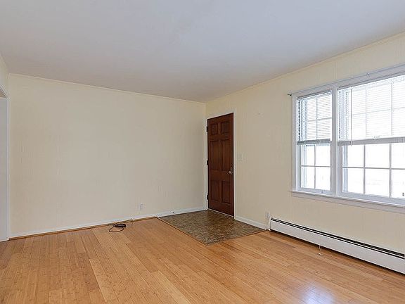 Living room with front door entrance.