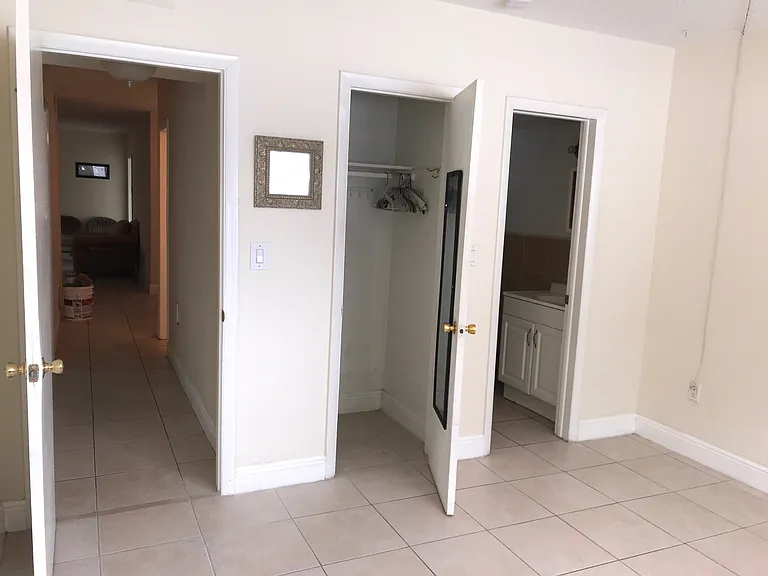 view of master bedroom bath, closet, and doorway to hallway