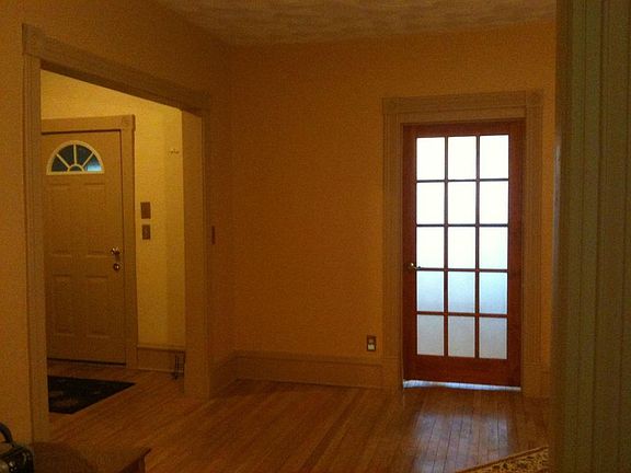 View of the front entry and sun room from the living room. Again, the foyer is quite large and can be used to store bicycles, as well as have a desk, mail center, or use as needed. The french door leads into the 4 season sun room