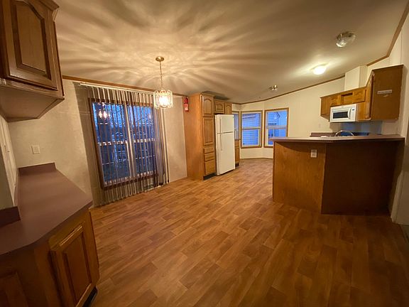 The large kitchen opens to the dining room which features built-in storage.