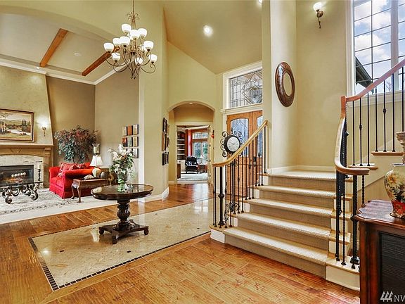 The iron spindle staircase lead to the upper level featuring 4 guest bedrooms, 2 full bathrooms, bonus room and additional rec room with a balcony overlooking the backyard oasis.