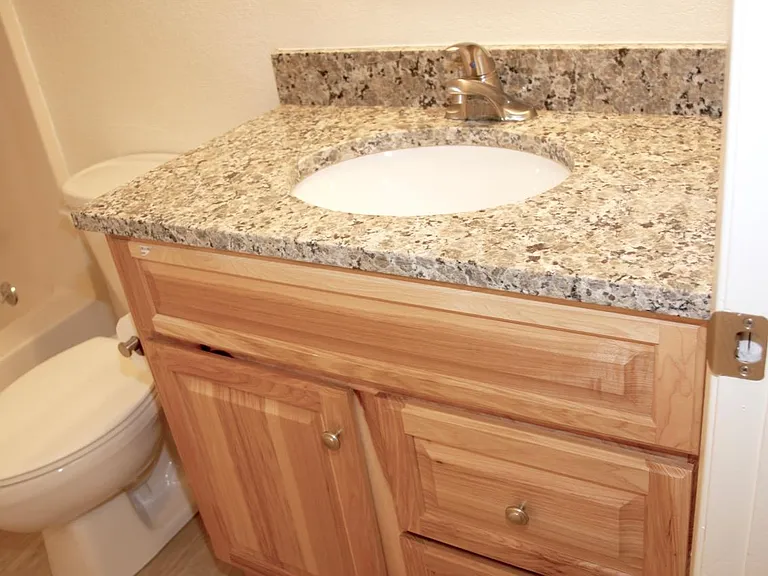 Bathroom updated in 2018, with new hickory vanity, new granite countertop, new satin nickel faucet.