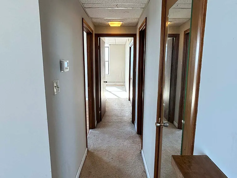 Hallway. Closet on right. 1st bedroom on left. Bathroom is second on the right. Bedroom 2 straight ahead.