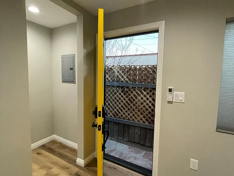 Entry door open to outdoor space.