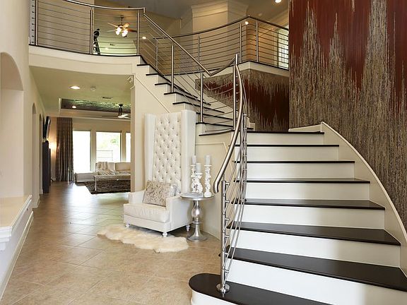 Awesome hand scraped wood stair case with custom cable stair railing system.