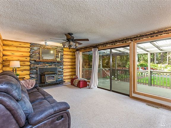 Great Room Living Space - Rock Fireplace w/Pellet Stove, Ceiling Fan & Slider to Exterior Covered Deck.