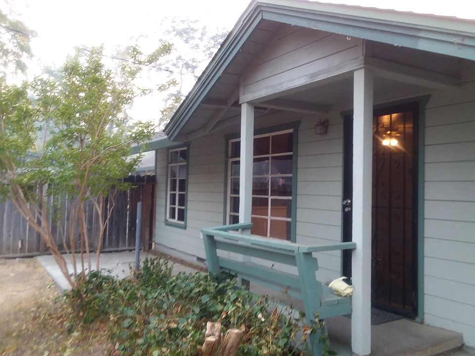 Front entry and porch with fenced front yard