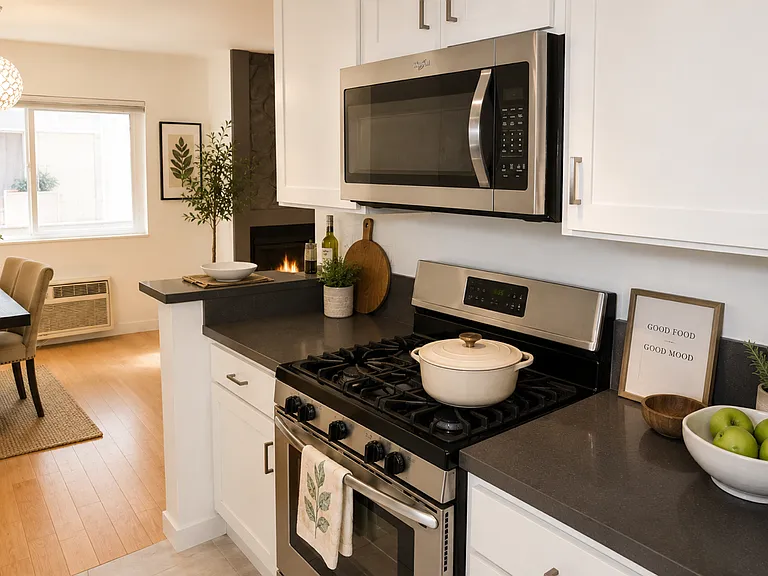 Galley kitchen with stainless steel appliances and gas stove and microhood.