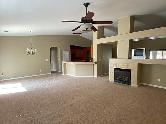 Another view of great room with fireplace and kitchen