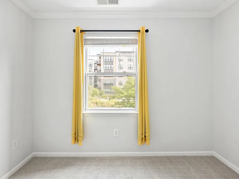 Main bedroom window with new curtain rods. Curtains are optional.