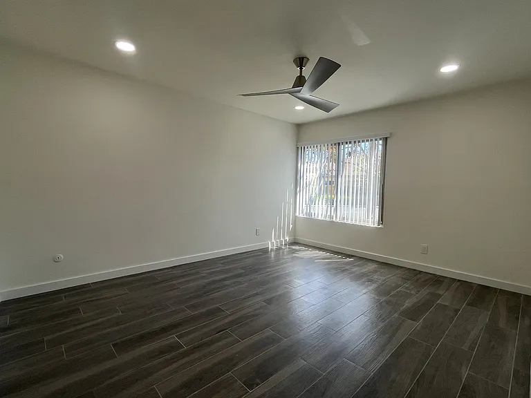 1544 #A7 - Bedroom with woodlike tile flooring and ceiling fan
