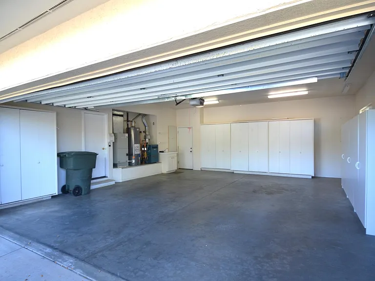 Enormous 2 car garage with tons of storage units & space to work... 18' wide door! (28'x24')