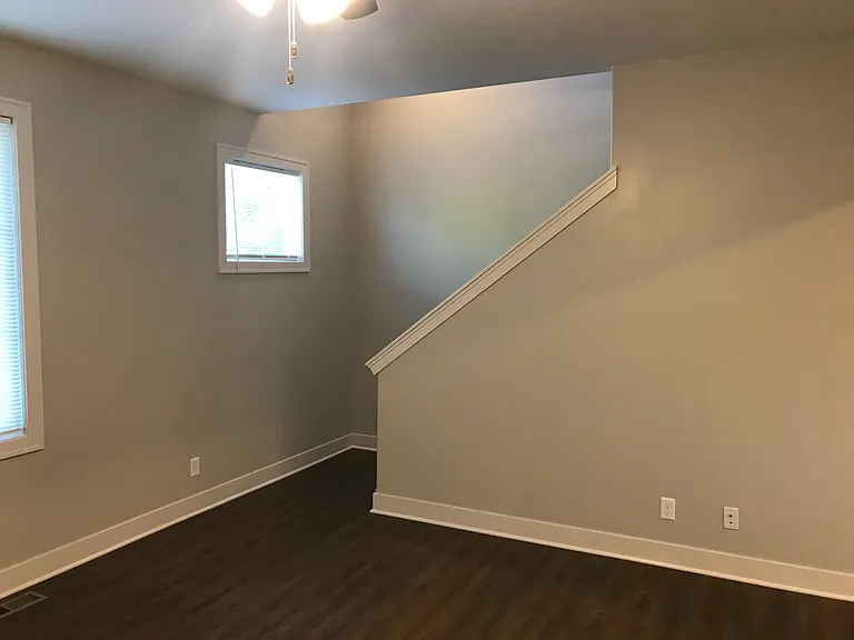 Living room showing stairs to top floor where there are 2 bedrooms