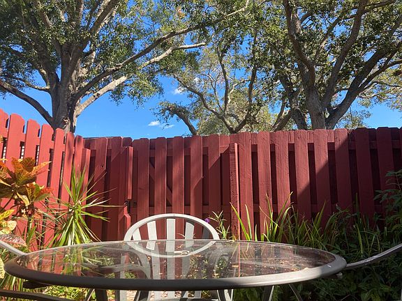 Patio enclosed with 6' fence under Oak trees