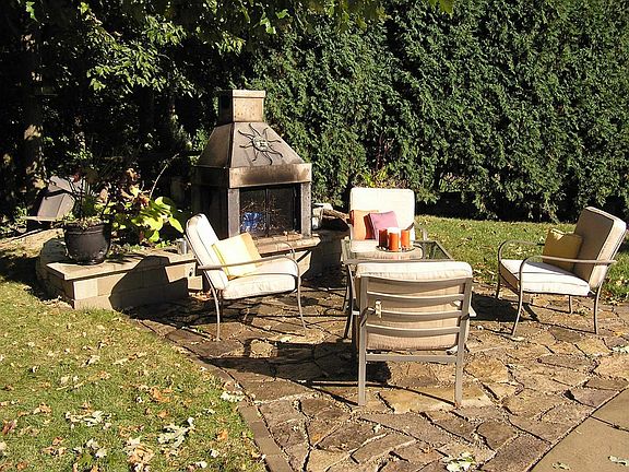 Backyard - Stone fireplace and Maumee River stone patio out back.