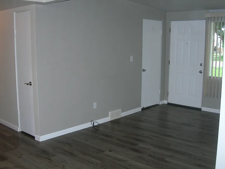 Living room with coat closet.