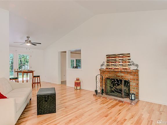 Soaring vaulted ceilings with wood burning fireplace.
