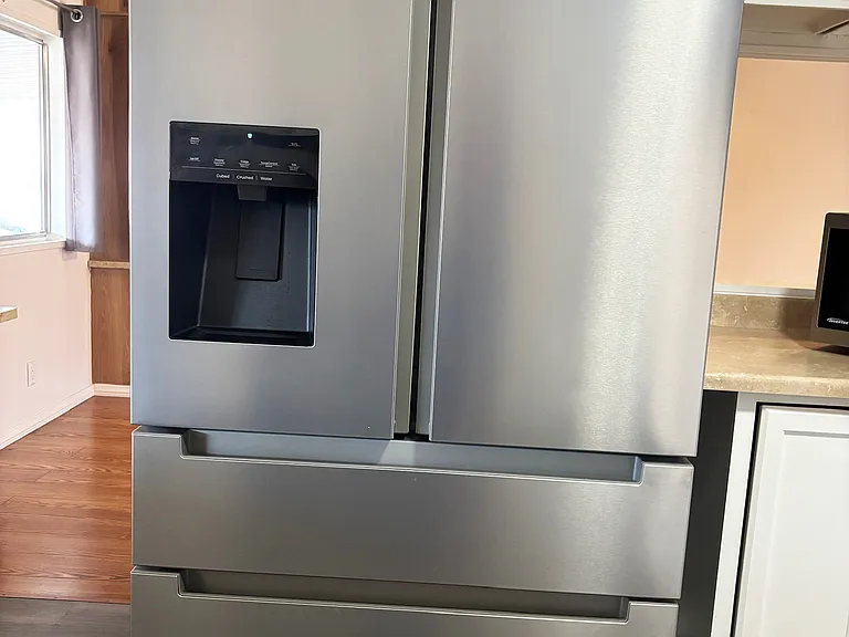 Brand new refrigerator with ice and water dispenser.
