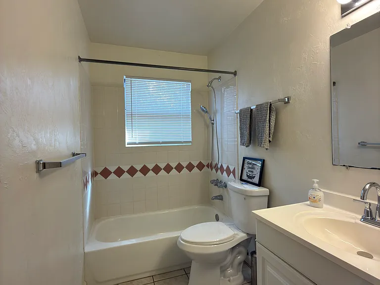 Large vanity, upscale toilette, full size shower with brand new multi-setting shower head and tub to soak in !