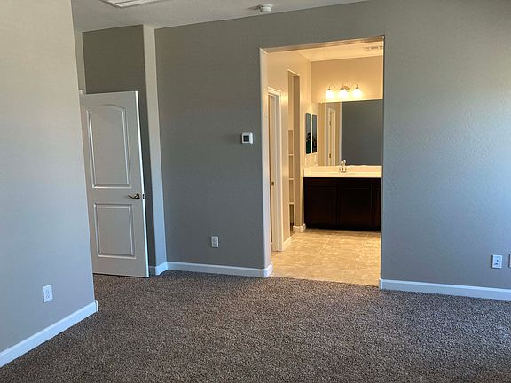 In Master bedroom looking toward bath. Walk in closet is to the left when you enter the bath