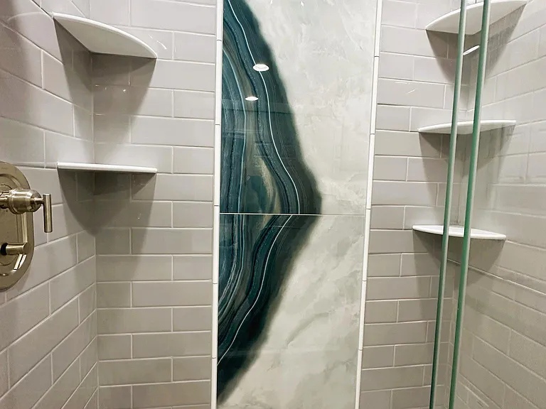 Shower has shower head and rain head.