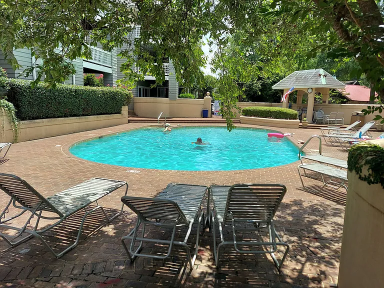 Step-in gunite pool, full paver surround, complete with lounge chairs included in this rental. C