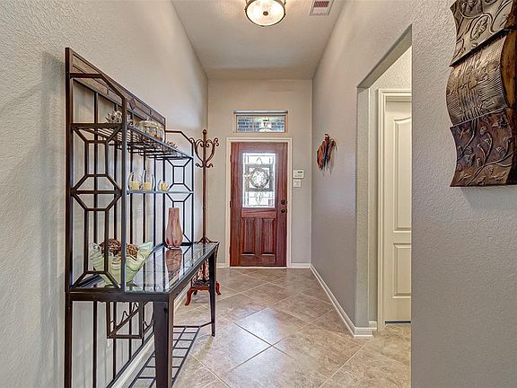 Foyer coming into the home with tile flooring.