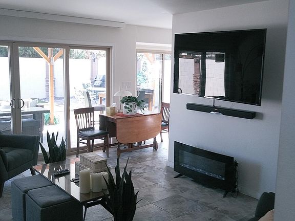 Open Concept with indirect light. 8 panes of glass south facing and shaded by 300+ feet of patio!