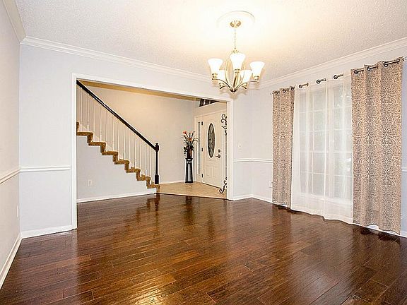 Big formal dining room with wideplank wood flooring.