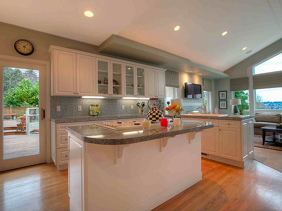 Gourmet kitchen complete with granite slab countertops and top-of-the-line appliances.  Breakfast nook off the kitchen that opens up to a large deck facing the sunny southside. 