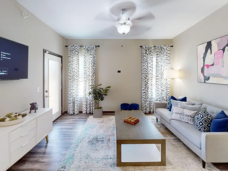 Our spacious living rooms feature wood-style flooring and natural light.