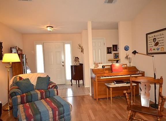 Enter through a bright foyer into an open family room.