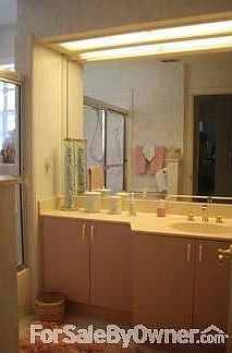 Guest Bath : Tub/Shower combo with sliding glass doors and plenty of cabinet space.