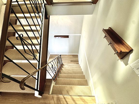 Stairs leading to the main floor. Wood coat hooks included for your convenience.
