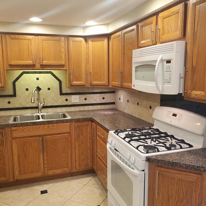 Kitchen area with gas range, built-in microwave, full custom