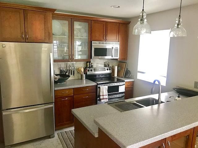 Kitchen with stainless steel appliances, including dishwasher