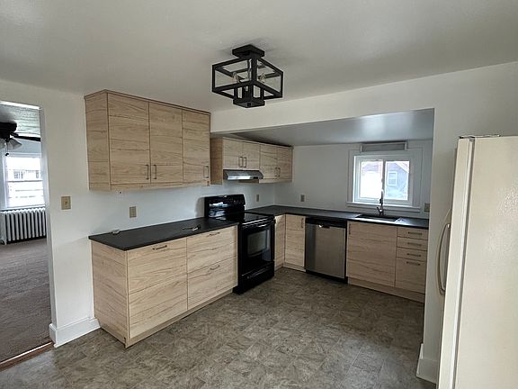 Spacious, updated kitchen includes dishwasher, washer/dryer hook-up, and kitchen table area not included in photo