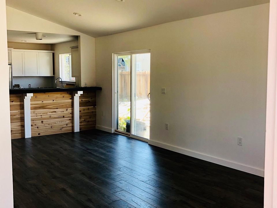 Entry into vaulted, open-concept Great Room with living, dining, and kitchen