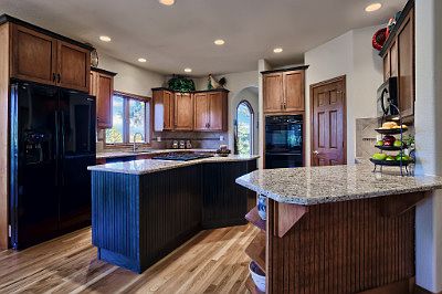 Gourmet kitchen w/ slab granite & hardwood floors