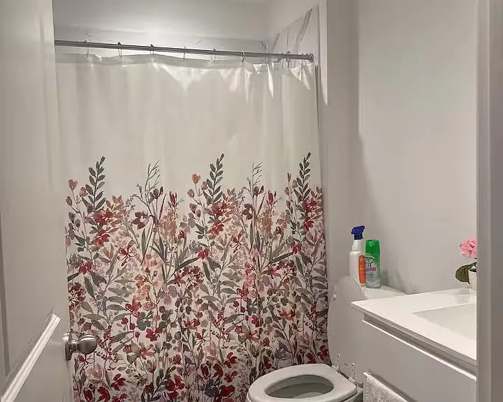 Full bathroom with a tub/shower combo, vanity with sink, and an exhaust fan for added ventilation.