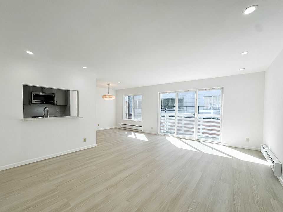 open layout living room and dining area with large windows