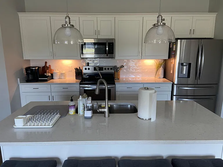 Kitchen with quartz countertops and multiple lighting options