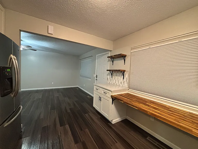 Built-in, desk-height butcher block counter faces the front yard. WFH or morning coffee!