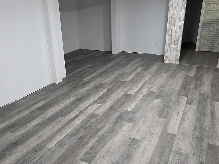 Partial finished basement for recreation or gym with half bathroom.