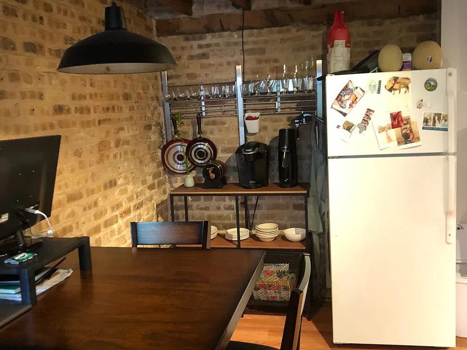 Eat in Kitchen with New fridge. Brick walls and ceiling painted white. It feels very open and bright