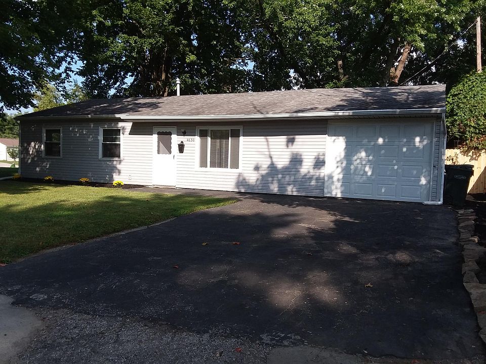 Front of house with attached garage and parking for two vehi