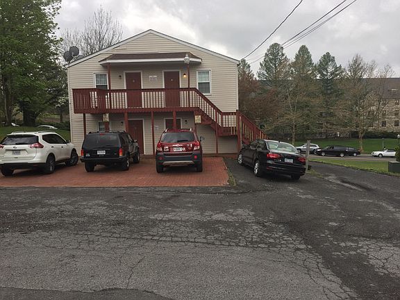 Rear of building and parking area, top left is this apartment. Also, bottom left is also available